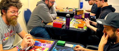 Group of people playing board games together in a casual setting