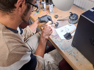 Man Airbrush painting models in Bristol